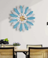 Blossom wall clock above a console table with books and plant décor